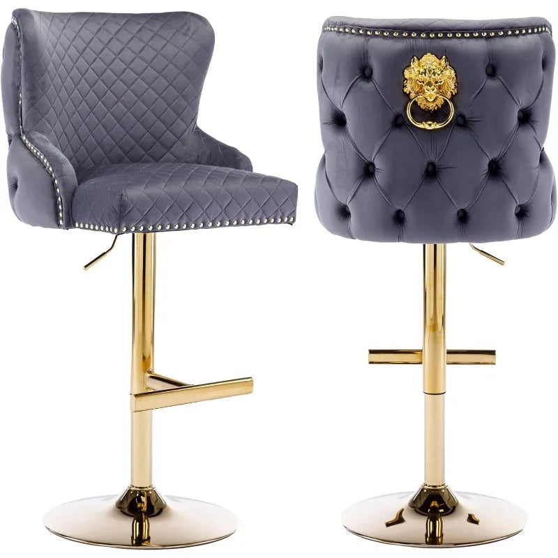 The Morsale Pull Ring Velvet Barstools Set of 2 features elegant gold bases, quilted dark blue upholstery, gold lion head ring backs, and nailhead trim. They include footrests and offer adjustable height for comfort and flexibility.