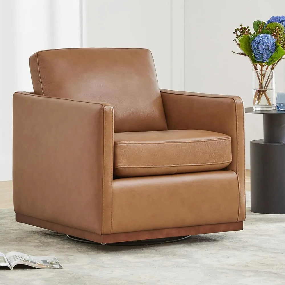 A Morsale Genuine Leather Swivel Lounge Chair sits on a light carpet. Nearby, a small side table holds a vase of blue and green flowers, while an open book rests thoughtfully on the floor to the left of the chair.