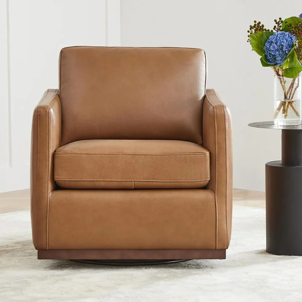 The Genuine Leather Swivel Lounge Chair by Morsale sits on a light rug, accompanied by an elegant round side table with a vase of vibrant blue hydrangeas and greenery, all set against a neutral-toned wall.