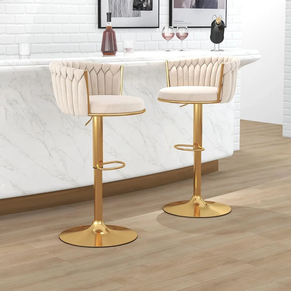 Two Morsale height-adjustable counter stools with gold bases and footrests enhance the minimalist modern design of a white marble bar. Each stool features cream cushioned seats with tufted backrests, paired with wine glasses, a wine bottle, and a black bottle opener for the perfect setting.