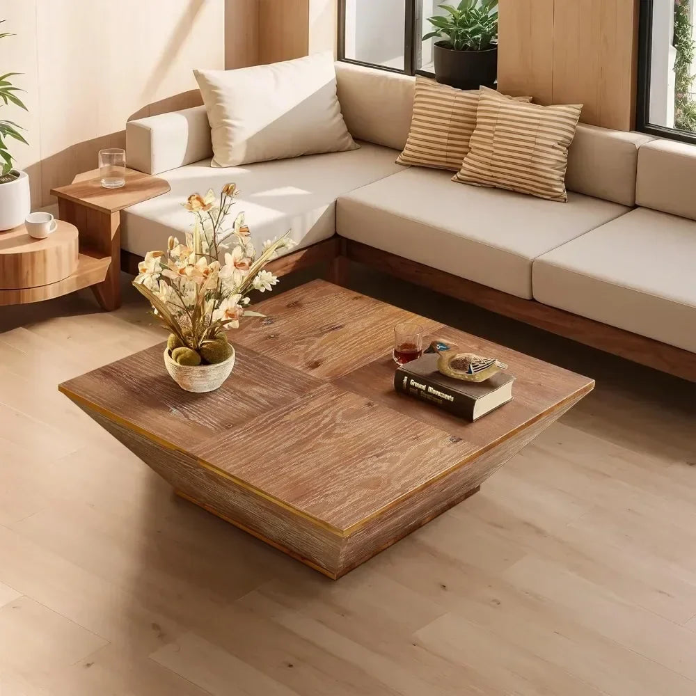 A cozy living room with a beige sectional sofa and striped pillows features a Morsale Lift Top Farmhouse Coffee Table adorned with books and a potted plant with white and yellow flowers. Natural light streams through large windows, illuminating the wooden floor in this modern minimalist design space.