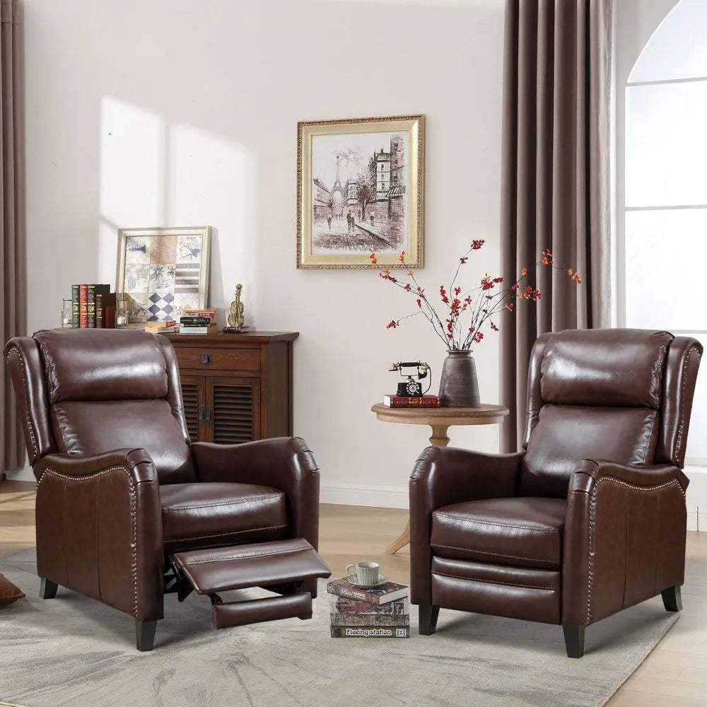 A cozy living room features two Morsale's Chester Genuine Leather Recliner Chairs, one elegantly reclined. A round wooden table with red flowers sits between them, a framed picture adorns the wall, and a wooden cabinet in the background showcases charming decor items.