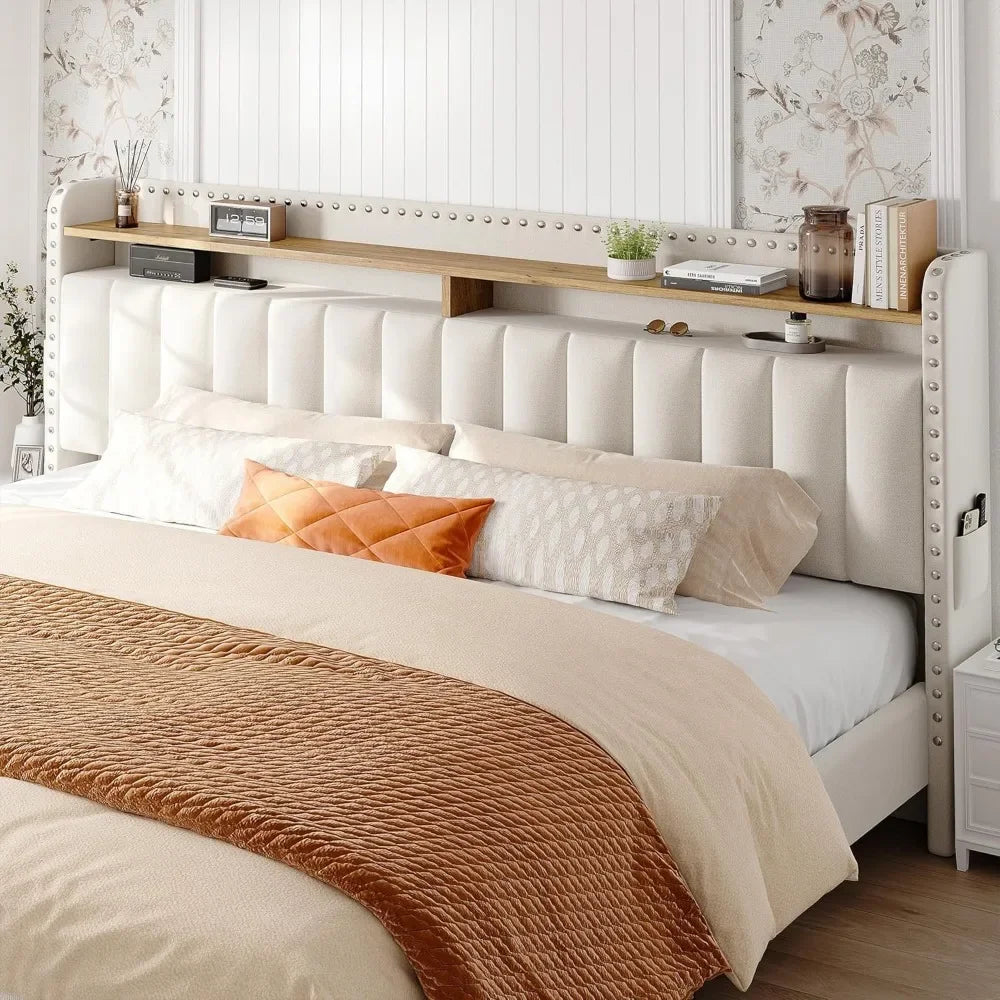 The Morsale Verano Bed Frame, featuring a modern tufted beige headboard with storage, displays an arrangement of pillows: two white, two light brown, and one orange accent pillow. Complemented by floral-patterned wallpaper, this stylish home furniture piece is crafted from composite fabrics.