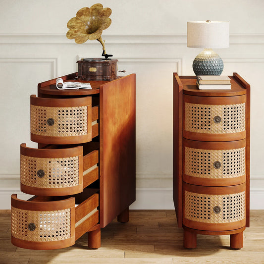 Two Morsale Irvine Solid Wood Side Tables with three wicker-front drawers each are placed side by side. The left one's drawers are open, while the right holds a lamp, plant, and books on top. Both feature a vintage finish and rest against a light-colored wall.