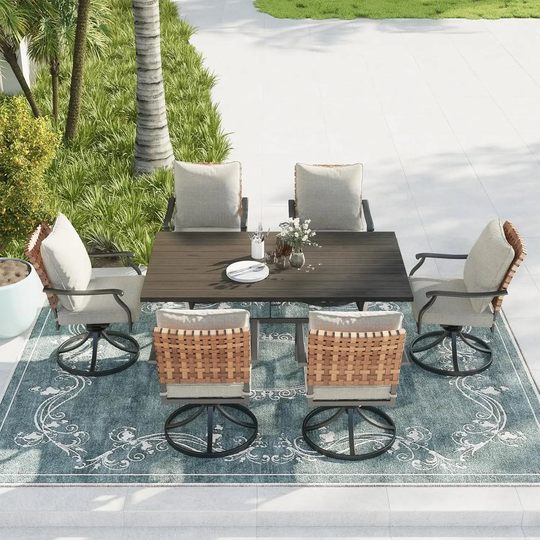 A minimalist modern patio scene features the Newport Grand Patio 7-Piece Outdoor Dining Set by Morsale, with a rectangular dark wood table and eight cushioned chairs surrounding it. A vase with white flowers and neatly arranged cups and saucers complete the set by the pool.