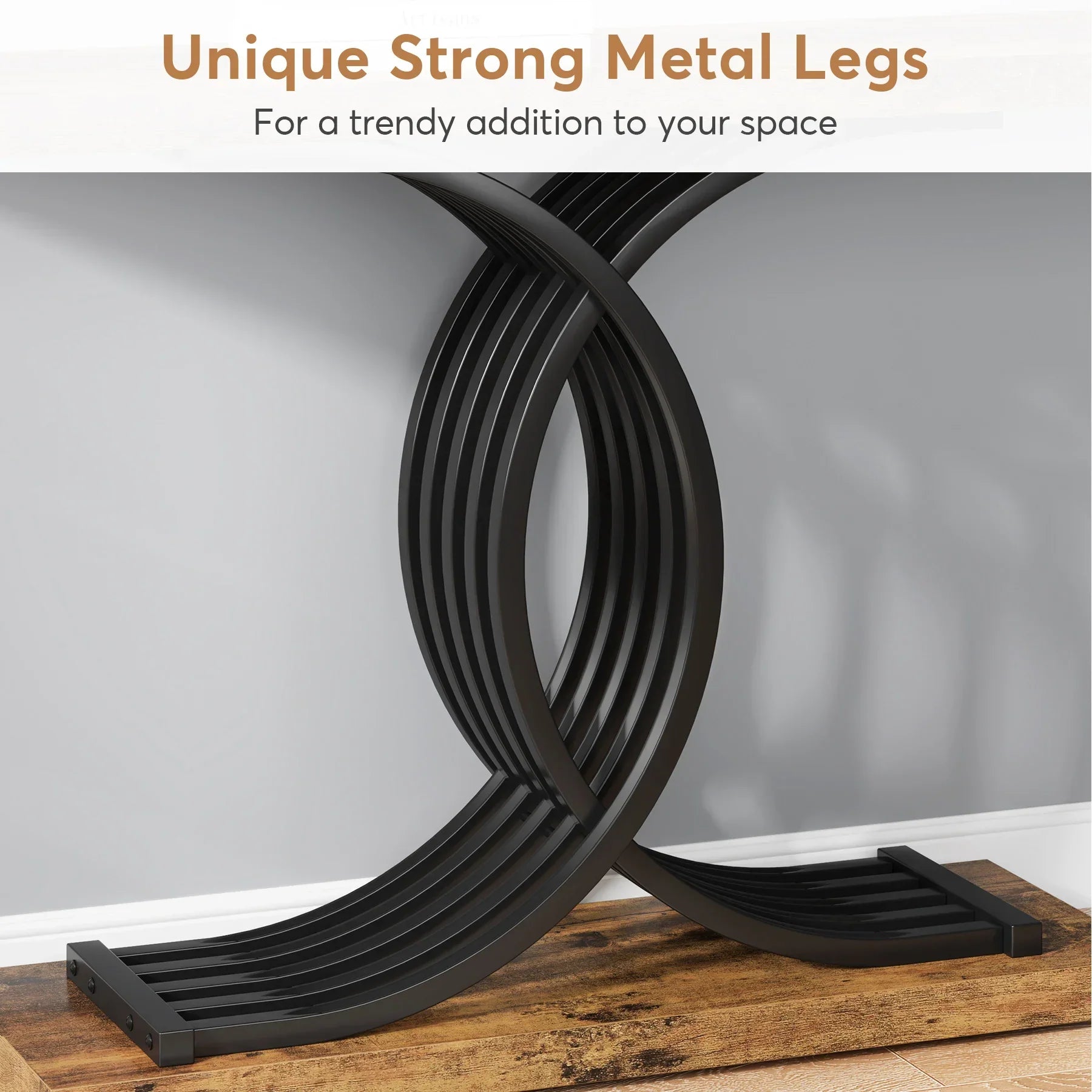 The Wexford Geometric Frame Console Table by Morsale features curved black metal legs forming an X shape, supporting a wooden tabletop against a gray wall. The text above states, "Unique Strong Metal Legs - For a trendy addition to your modern style space.