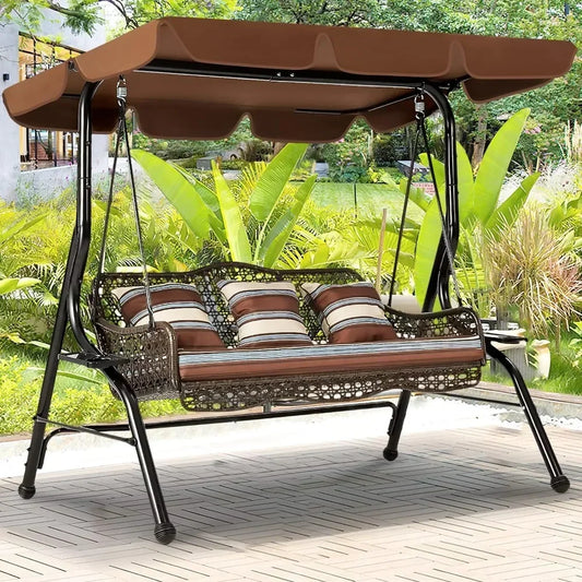 The Morsale Lewes 3-Seat Porch Swing Chair features a brown canopy and cushioned seats with striped pillows. Easy to assemble, it's perfect on a patio surrounded by lush foliage and a manicured garden—ideal outdoor furniture.
