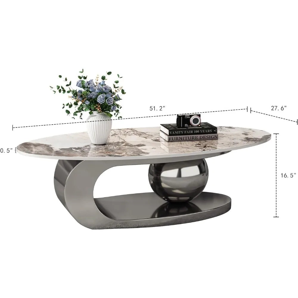 The Morsale Modern Coffee Table features an oval ceramic top and a unique steel base with a spherical accent. It's crafted chemical-free in Mainland China and styled with blue flowers, books, and a decorative camera. Dimensions: 51.2" x 27.6" x 16.5".