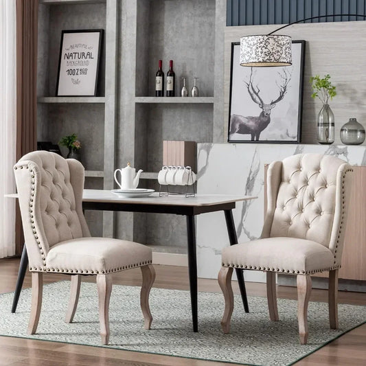 A modern dining area showcases a light wood table paired with Morsale's Farmhouse Dining Room Chairs, featuring beige upholstery and tufted backs. A teapot and cups sit on the table, framed by a deer picture and wine bottles on shelves, while a patterned linen rug enhances floor texture.