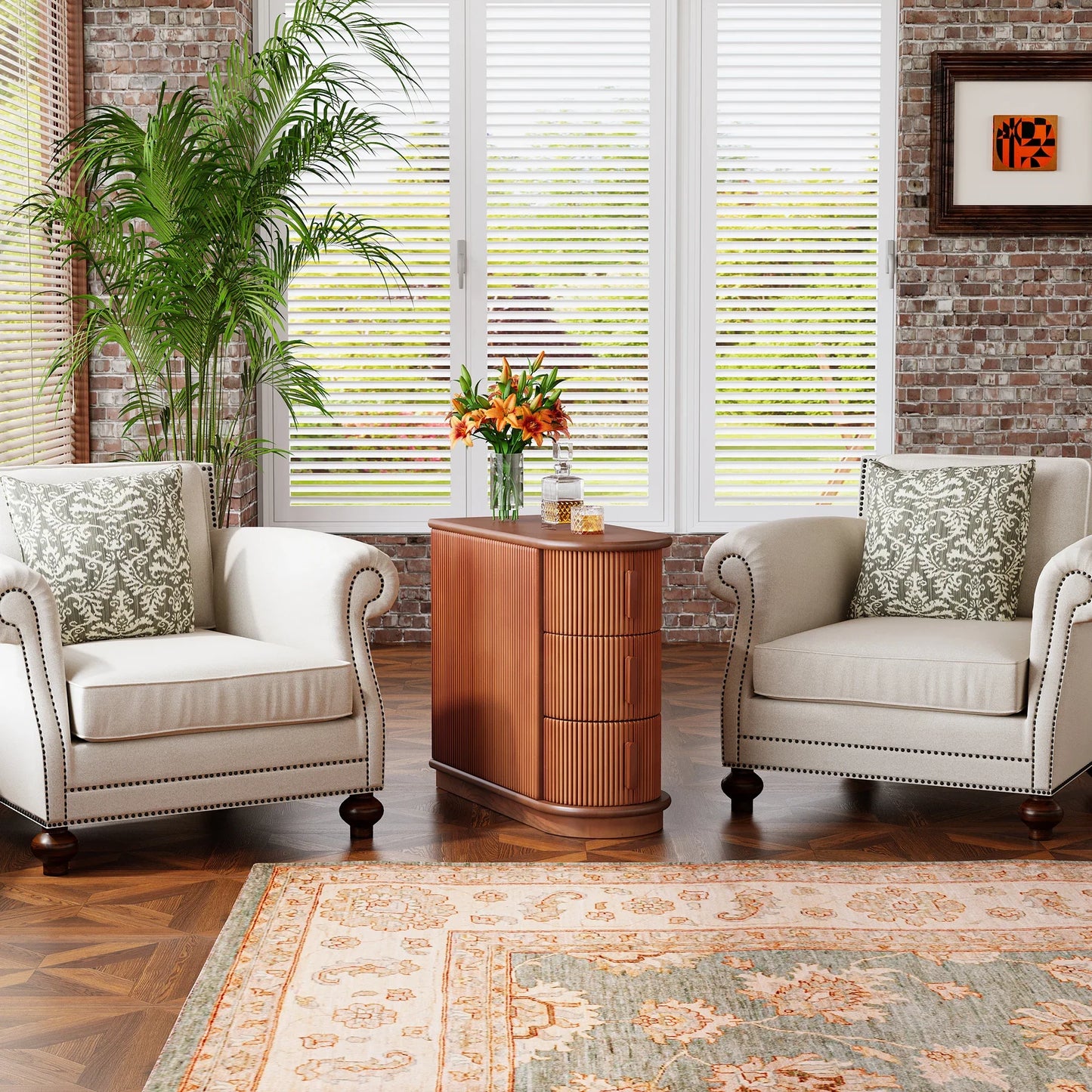 A cozy sitting area features two beige armchairs with decorative pillows around the Morsale Irvine Solid Wood Side Table. The space boasts a potted plant, large windows, and a brick wall for added charm, while a patterned rug and vintage finish complete this inviting setup.