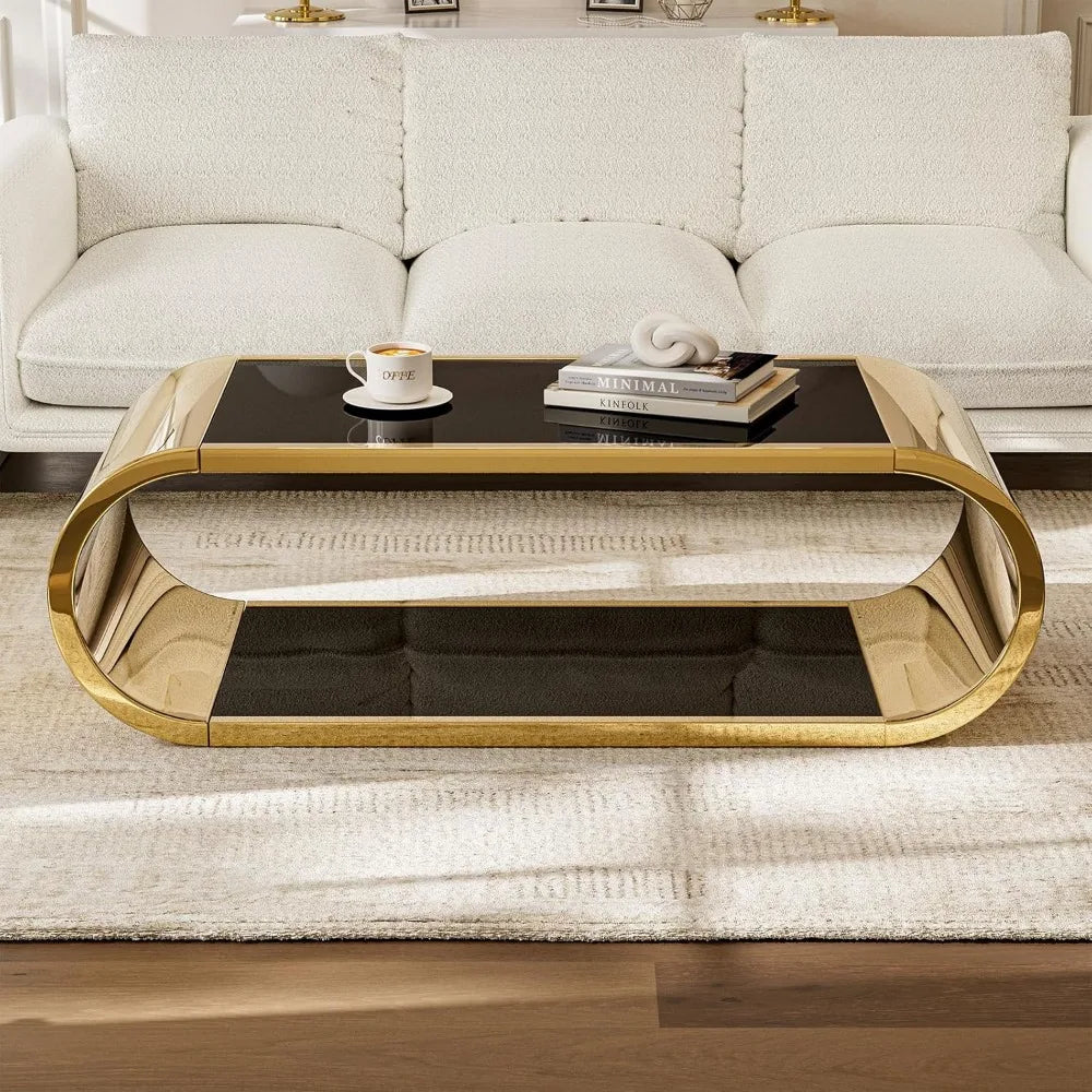 A luxurious living room showcases a white textured sofa and the elegant Morsale Stainless Steel & Glass Coffee Table, featuring a glossy black top with gold frame. A coffee cup and book rest on a light beige rug over wooden flooring, enhancing the exquisite scene.