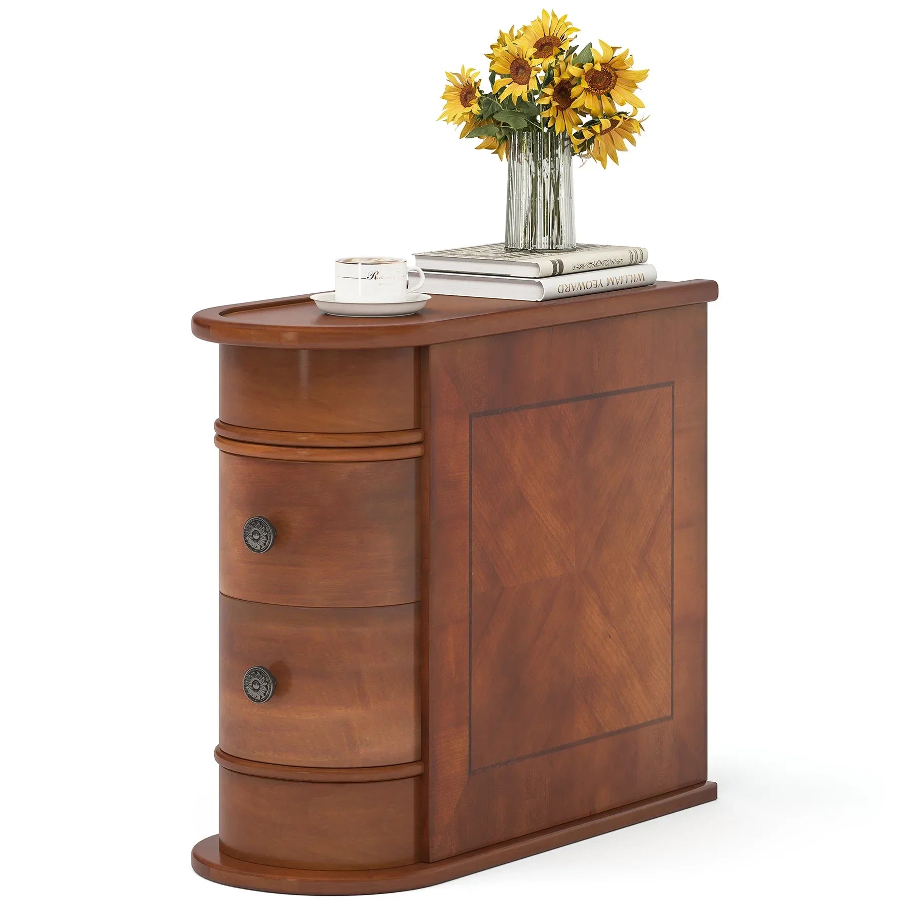 The Morsale Irvine Solid Wood Side Table features three drawers with ornate handles and showcases minimalist modern charm in a warm brown finish and rectangular design. On top, it holds a vase of sunflowers, two books, and a coffee cup.