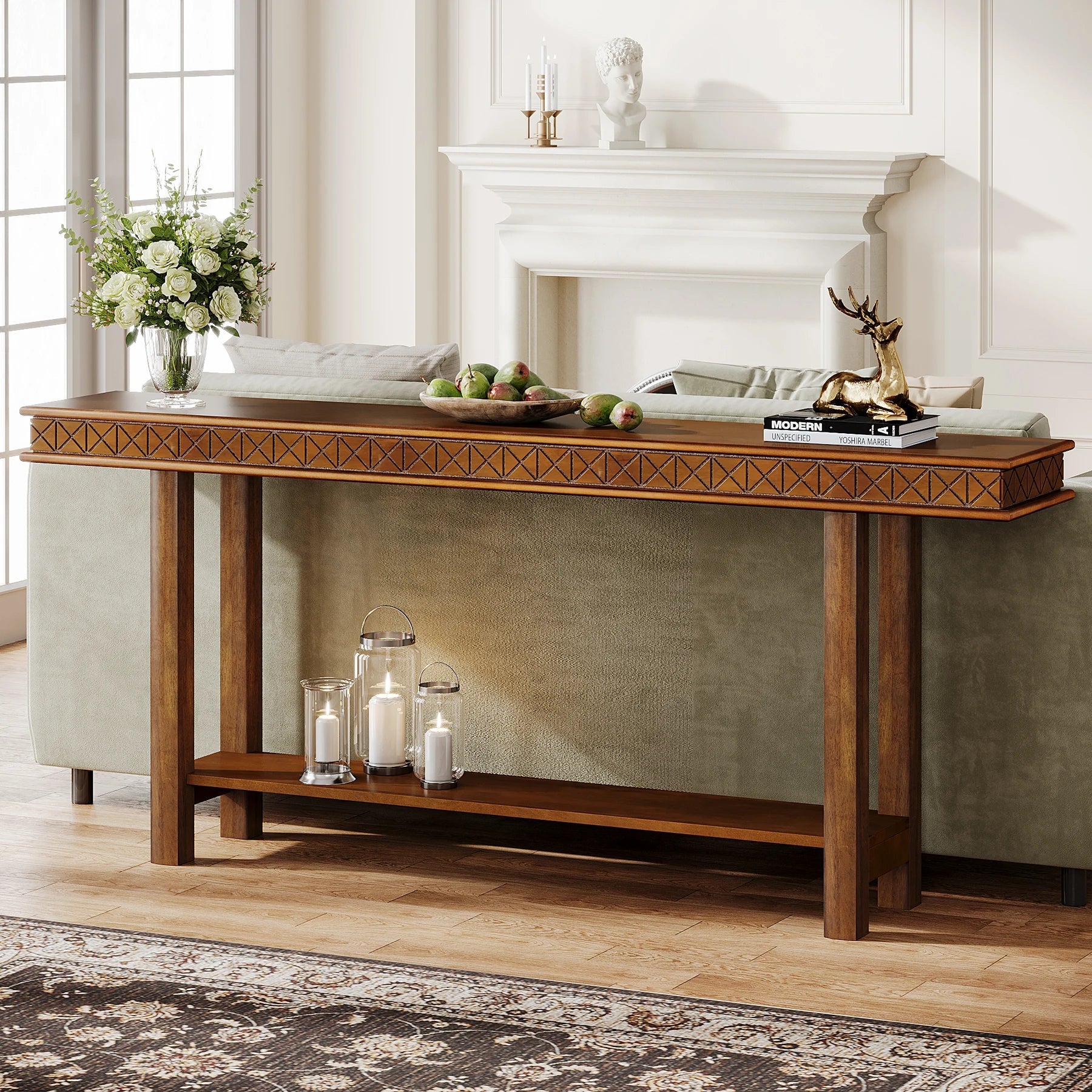 The Stanton Entryway Table With Storage by Morsale, featuring a modern wood design with geometric accents, beautifully complements the couch. It holds decor items like candles, green apples, and a gold deer sculpture while a vase by the fireplace enjoys soft light from large windows.