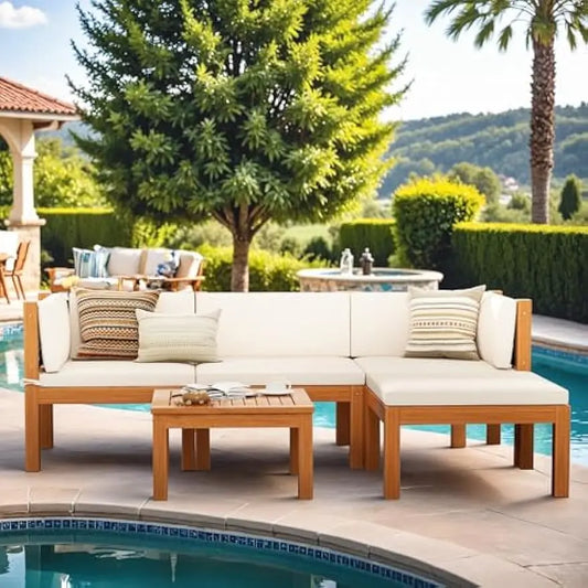 The serene outdoor patio showcases the Morsale Ryde Patio Sectional Sofa with white cushions, striped pillows, and a matching Acacia Wood Table, an ideal setup for enjoying views of the pool, trees, and hills.