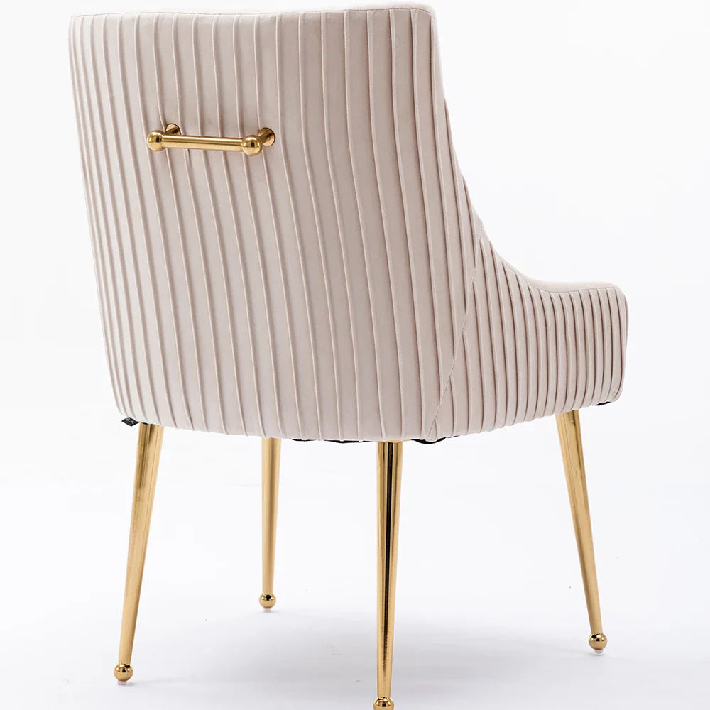 The Morsale Modern Glam Boucle Pleated Velvet Dining Chair Set of 4 features beige vertical-stitched upholstery, gold legs, and a horizontal gold backrest handle. Its elegant design complements home settings against a plain white background.
