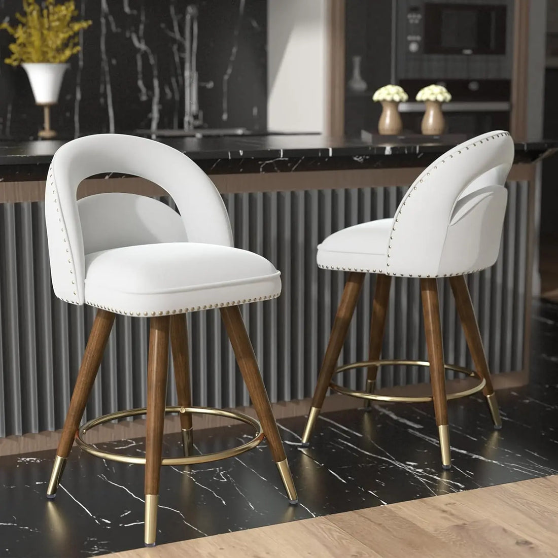 The Morsale Counter Height Swivel Bar Stools Set of 2, with white cushioned seats, wooden legs, and brass accents, enhance a sleek kitchen with black marble countertops. Imported from Mainland China, they are easy to assemble on alternating black tile and light wood floors.