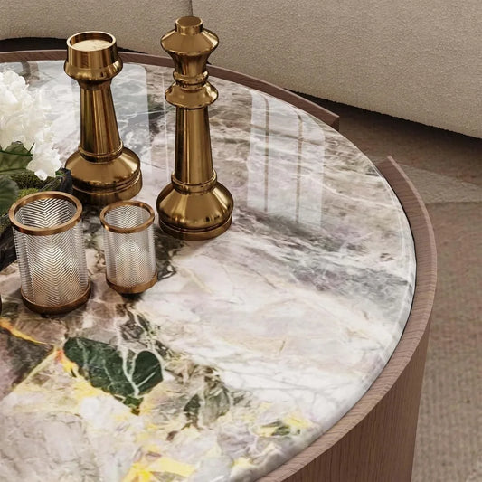 The 35" Modern Coffee Table by Morsale, featuring a glossy marble surface and wooden edge, is adorned with gold candle holders and delicate white flowers. It complements muted fabric settings while reflecting light gently, adding a touch of modern style.
