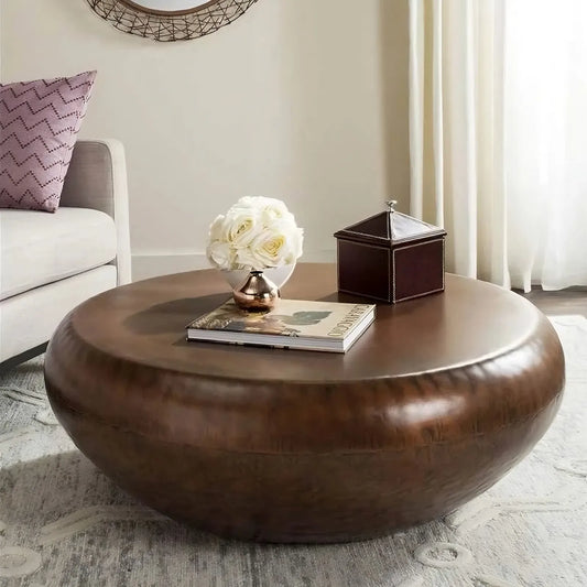 The 39" Iron Coffee Table by Morsale adds modern sophistication to the living room, adorned with a book, a decorative box, and a vase of white roses. It pairs elegantly with a light-colored sofa and patterned rug as sunlight streams through sheer curtains.