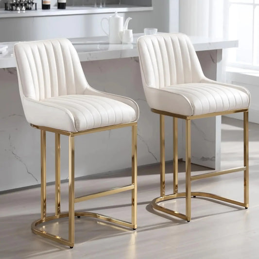 The Morsale Modern Counter Height Bar Stools Set of 2, with luxurious white upholstery and vertical stitching on sleek gold metal frames, are elegantly showcased before a marble-accented kitchen island, adding sophisticated contemporary flair.